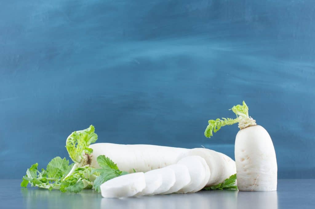 Daikon radish is a popular root vegetable in Asian and Indian cooking belonging to the cruciferous vegetable family. Daikon radish has become a staple ingredient in various cuisines worldwide with its distinctive elongated shape and crisp texture.